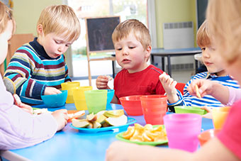 children eating snacks at a nursery